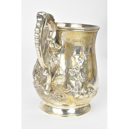 22 - A Victorian silver mug, by Robert Harper, hallmarked London 1857, the embossed baluster formed body ... 