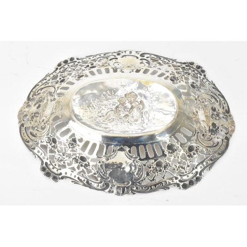 24 - A 19th century continental silver dish, stamped J.B 800, profusely decorated and pierced with cherub... 