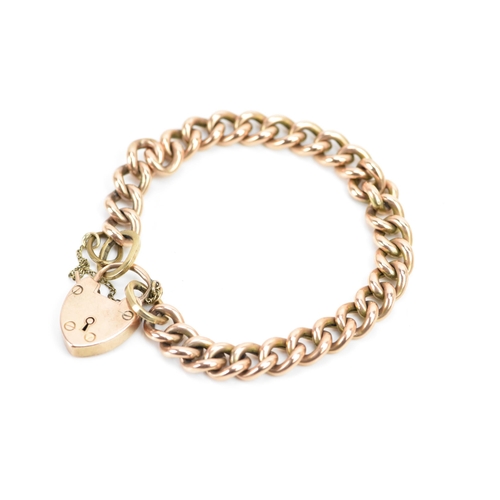 244 - A rose gold coloured curb link bracelet, with a safety chain and a 10ct gold hallmarked heart shaped... 