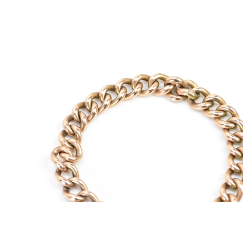 244 - A rose gold coloured curb link bracelet, with a safety chain and a 10ct gold hallmarked heart shaped... 