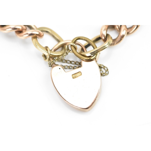 244 - A rose gold coloured curb link bracelet, with a safety chain and a 10ct gold hallmarked heart shaped... 