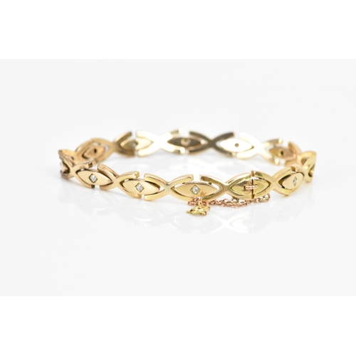 255 - A yellow gold and diamond bracelet, each of the oval links inset with a single diamond in a claw set... 