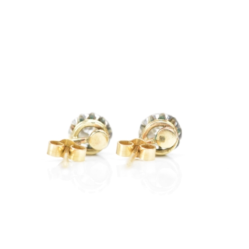 257 - A pair of white and yellow gold diamond earrings, each having an old cut stone in a claw setting, ap... 