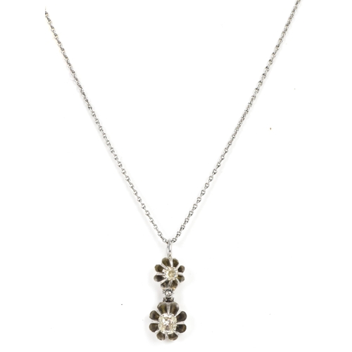 258 - A white gold and diamond necklace, the pendant drop having two diamonds each in a flower head settin... 