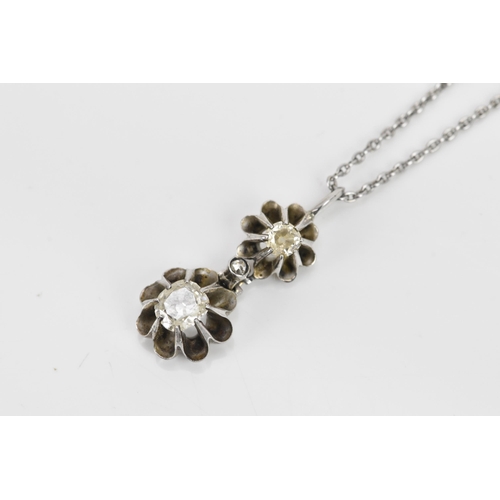 258 - A white gold and diamond necklace, the pendant drop having two diamonds each in a flower head settin... 