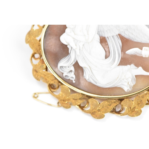 264 - A Victorian yellow metal cameo brooch, of oval form, the cameo depicting a guardian angel carrying t... 