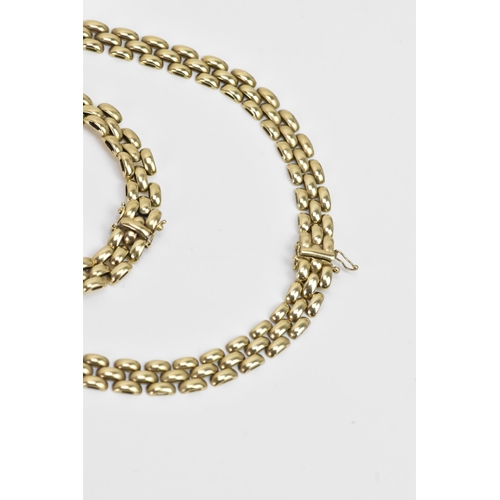 265 - A 9ct gold panther chain link necklace and matching bracelet, both with open box clasps, the necklac... 