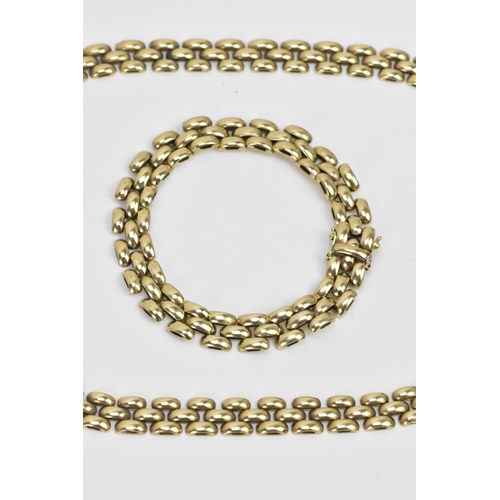 265 - A 9ct gold panther chain link necklace and matching bracelet, both with open box clasps, the necklac... 