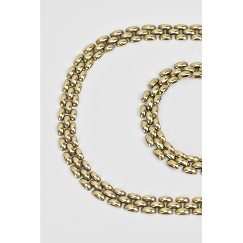 265 - A 9ct gold panther chain link necklace and matching bracelet, both with open box clasps, the necklac... 