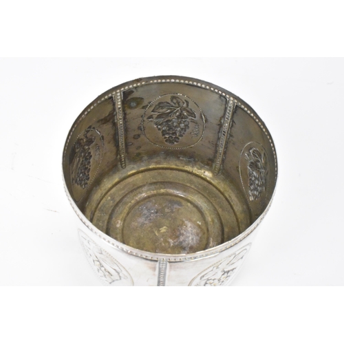 27 - An early 20th century white metal continental wine bottle coaster, of circular form, embossed with c... 