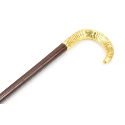 270 - A gold handled walking stick, tested as 14ct gold, the handle of reeded form and stamped G.O.P, on a... 