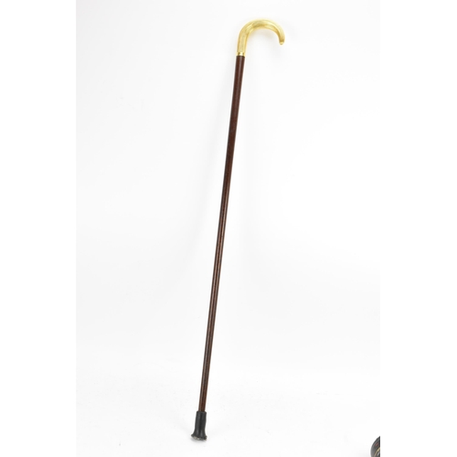 270 - A gold handled walking stick, tested as 14ct gold, the handle of reeded form and stamped G.O.P, on a... 