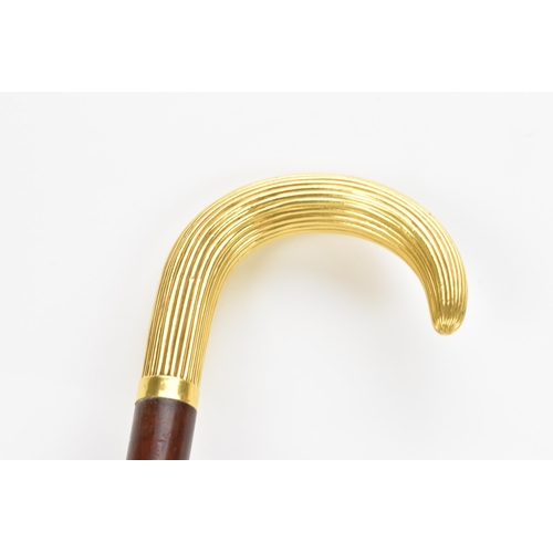 270 - A gold handled walking stick, tested as 14ct gold, the handle of reeded form and stamped G.O.P, on a... 