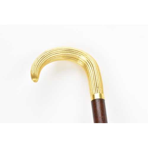 270 - A gold handled walking stick, tested as 14ct gold, the handle of reeded form and stamped G.O.P, on a... 