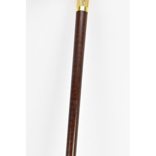 270 - A gold handled walking stick, tested as 14ct gold, the handle of reeded form and stamped G.O.P, on a... 