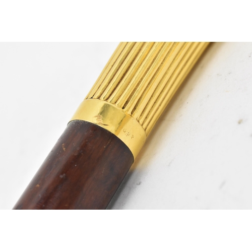 270 - A gold handled walking stick, tested as 14ct gold, the handle of reeded form and stamped G.O.P, on a... 