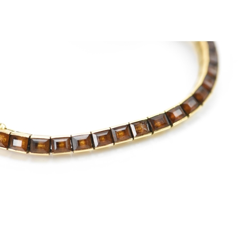 283 - A Cartier mid 20th century gold and Citrine line bracelet made into a watch strap and fitted to a la... 