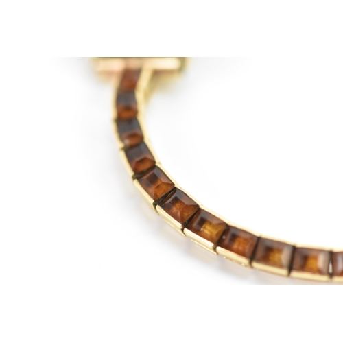 283 - A Cartier mid 20th century gold and Citrine line bracelet made into a watch strap and fitted to a la... 