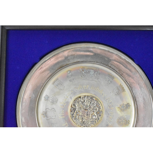 3 - An Elizabeth II silver commemorative dish, Birmingham 1977, with central raised gilt roundel with co... 