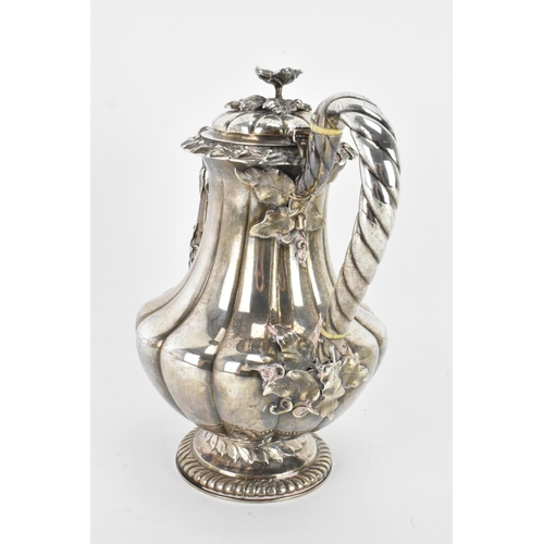 31 - A late 19th century Indian silver coffee pot, hallmarks for Calcutta 1860-1914, having a flower shap... 