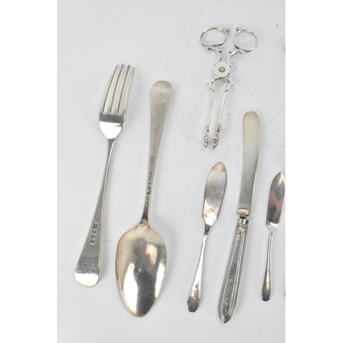 40 - A selection of various silver utensils with various dates and makers to include a Victorian cheese s... 