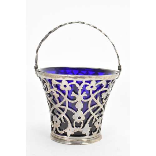 45 - A late 19th/early 20th century silver small basket, marks rubbed, having a blue glass liner, rope tw... 