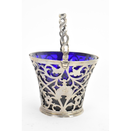 45 - A late 19th/early 20th century silver small basket, marks rubbed, having a blue glass liner, rope tw... 