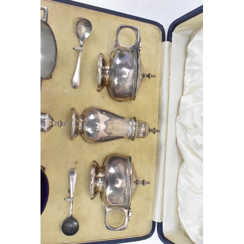 60 - A George V silver cased cruet set by Mappin & Webb, hallmarked Birmingham 1928, consisting of two mu... 