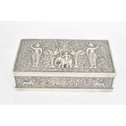 62 - An early/mid 20th century Indian silver cigarette box, the lid and side panels embossed with scenes ... 