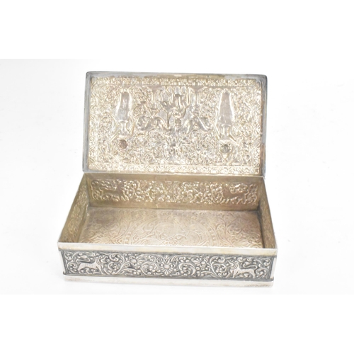 62 - An early/mid 20th century Indian silver cigarette box, the lid and side panels embossed with scenes ... 