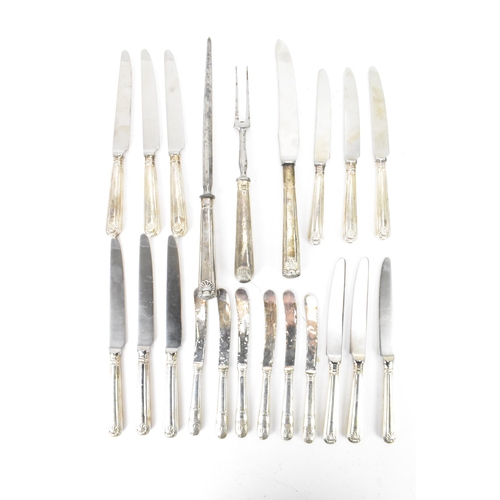 91 - A selection of 19th century and later silver handled cutlery to include a carving steel and knife by... 