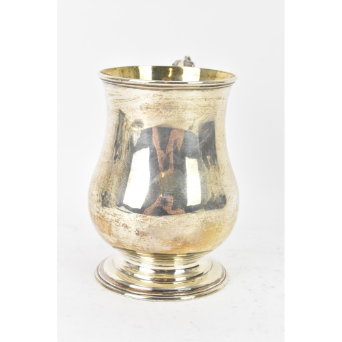 97 - A Victorian silver tankard hallmarked London 1877, makers marks rubbed, the body of baluster form an... 