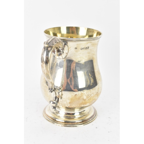 97 - A Victorian silver tankard hallmarked London 1877, makers marks rubbed, the body of baluster form an... 