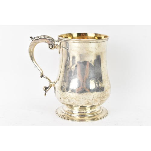 98 - A Victorian silver tankard hallmarked London 1861, makers marks rubbed, the body of baluster form an... 