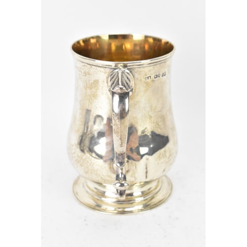 98 - A Victorian silver tankard hallmarked London 1861, makers marks rubbed, the body of baluster form an... 