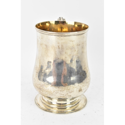 98 - A Victorian silver tankard hallmarked London 1861, makers marks rubbed, the body of baluster form an... 