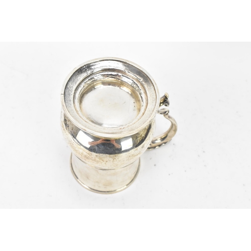 98 - A Victorian silver tankard hallmarked London 1861, makers marks rubbed, the body of baluster form an... 