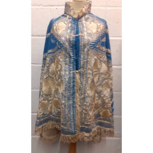 39 - A mid 19th Century Anglo-Indian embroidered cape having blue ground with intricate cream silk embroi... 