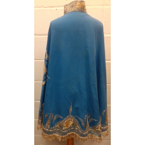 39 - A mid 19th Century Anglo-Indian embroidered cape having blue ground with intricate cream silk embroi... 