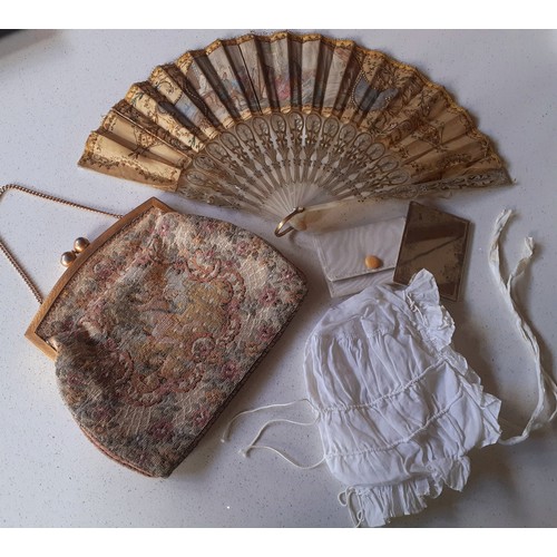 157 - A 19th Century mother of pearl wand and cream silk fan decorated with embroidery, sequins and images... 