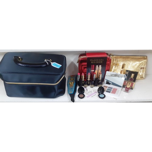 156 - An Estee Lauder cosmetic case with unused contents to include an Elizabeth Red Door purse vaporiser ... 