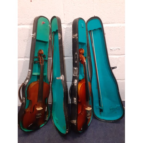 194 - Two student violins to include a Lark together with 2 hard cases and 2 bows. Location:RWF