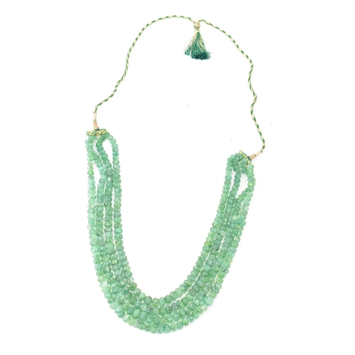 267 - An emerald coloured bead necklace comprising of four rows of emerald beads, knotted to a green and g... 