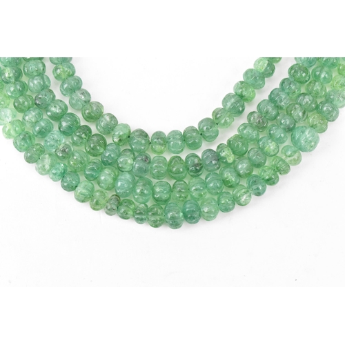 267 - An emerald coloured bead necklace comprising of four rows of emerald beads, knotted to a green and g... 