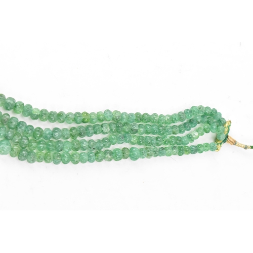 267 - An emerald coloured bead necklace comprising of four rows of emerald beads, knotted to a green and g... 