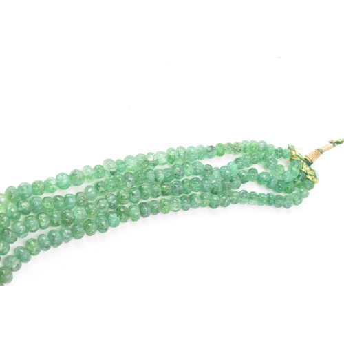 267 - An emerald coloured bead necklace comprising of four rows of emerald beads, knotted to a green and g... 