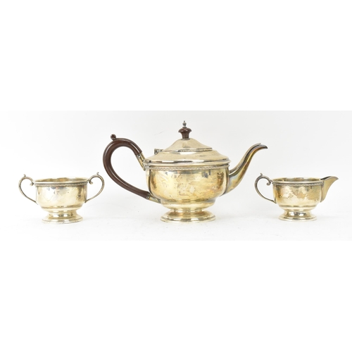 290 - A George V silver three piece tea service, hallmarked Birmingham 1932, consisting of a teapot, milk ... 