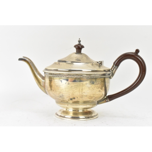 290 - A George V silver three piece tea service, hallmarked Birmingham 1932, consisting of a teapot, milk ... 