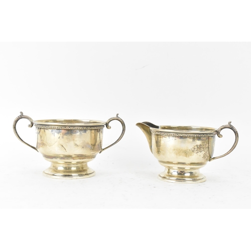 290 - A George V silver three piece tea service, hallmarked Birmingham 1932, consisting of a teapot, milk ... 