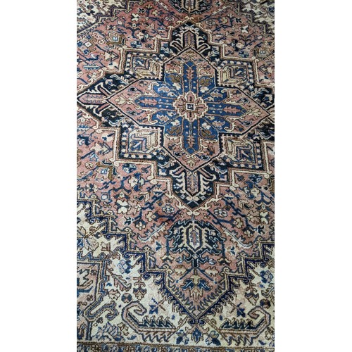 306 - A Persian handwoven rug having a central motif and geometric designs 333cm x 250cm Location:FOYER
If... 